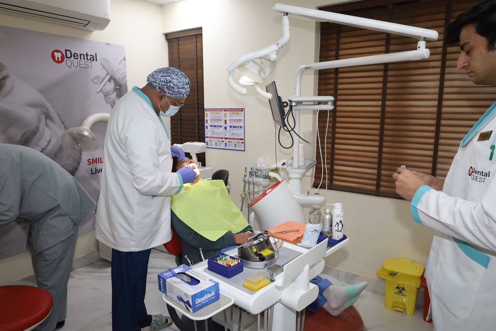 Dentists treating a patient in the operatory at Dental Quest clinic, Dwarka Sector 19